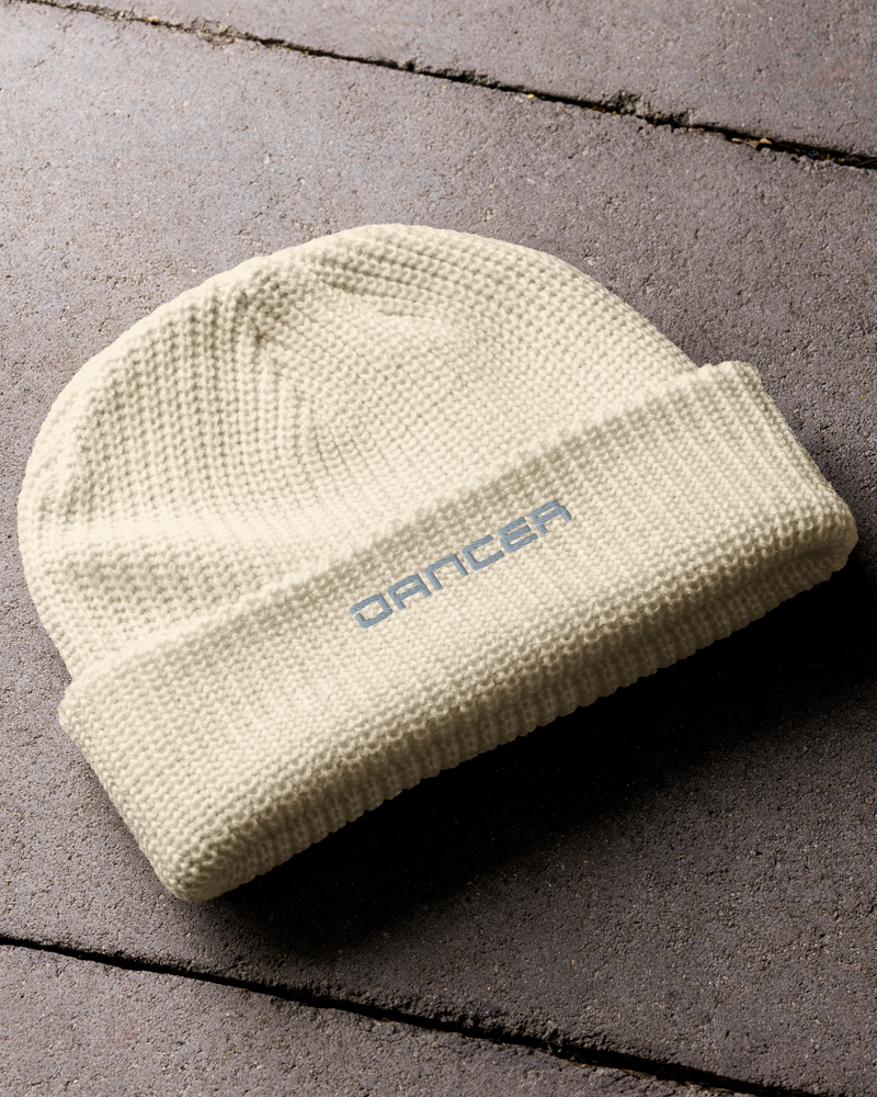 Fisherman beanie cream flat on concrete