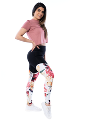 model wearing high waisted leggings in floral pattern and pink crop tee