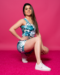 high waisted shorts and crop top in white and green pattern on a pink background lower on the floor