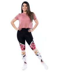 model posing in pink crop tee and floral leggings